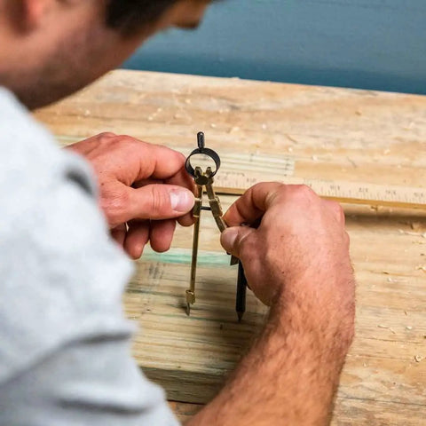 Job Site Ready Rock Solid Precision Pencil Compass With Snap Lock Spring Tension and Nine Inch Layout Span on a workbench.