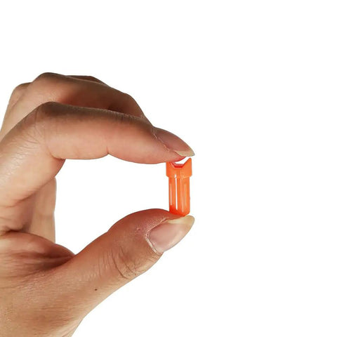 Half Moon Arrow Nocks 50 Pack Plastic Crossbow Nocks For 7.6mm ID Bolts Orange Replacement Tips held between fingers