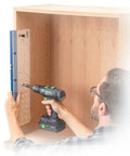 Man using Shelf Pin Drilling Jig For Cabinets And Woodworking With 1/4 Inch And 5mm Self Centering Bits inside a wooden cabinet