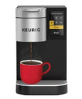 Front view of fast single serve commercial coffee maker with 4 to 12 oz cup sizes, brewing hot coffee into red mug.