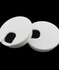 Two white plastic desktop cable hole covers, two point five inch diameter, for neat desk organization and cord management.