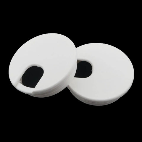 Two white plastic desktop cable hole covers, two point five inch diameter, for neat desk organization and cord management.