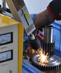 Front view of SFX EDM-8C 800W tap burner; yellow control panel with gauges as sparks fly while a tool works on a gear.