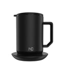 Smart Self Heating Coffee Mug With Gravity Sensor Coaster And Lid Holds Ideal Heat For Office Or Home Use Solid Stainless Steel Build Keeps Your Daily Grind Smooth Through The Afternoon Slump Sharp Black 12 Oz Mug on a coaster