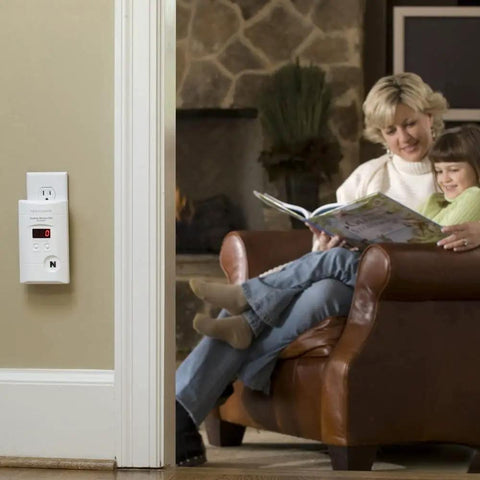 Plug In Carbon Monoxide Alarm With 9 Volt Battery Backup, Digital LED Display, 85 Decibel Siren installed on wall in living room.