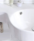 Slick Ceramic Wall Mounted Bathroom Sink With Deep Corner Basin and Standalone Pedestal Base for quick clean up, showing smooth glaze and drain.