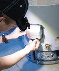Person wearing Cap Visor Clip LED Light With Pivoting Head, Battery-Powered 2xAAA, working on appliance.