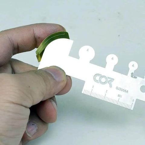 Close-up of Photo Etched Hobby Etching Kit With Stainless Steel Sheet Bender Tool, showing details of ruler use.