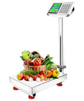 Built Tough Folding Platform Scale With Sharp Digital Readout And Plug In Rechargeable Base For Heavy Lifting At The Warehouse Or Managing Bustling Shipping Depots Up To Eight Hundred Eighty Pounds with vegetables and fruit on stainless steel deck.