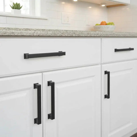 Rock Solid Matte Black Cabinet Pulls And Drawer Handles 5 Inch 10 Pack installed on white kitchen cabinets