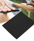 Top Tier 100 Piece Sandpaper Sheets For Woodworking Pros in use on wood surface for polishing with black aluminum oxide paper.