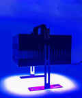 Heavy Duty UV Curing Lamp For Flatbed 3D Printers positioned on a work surface, emitting blue light for resin curing.
