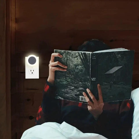 Manual LED Night Light With High Low Off Switch 20 Lumens Brightness Glare Free Warm White 3000K next to person reading