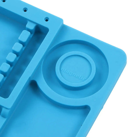 Close-up of Pro Grade Silicone Electronic Repair Mat with magnetic screw slots and attachment holes in blue.
