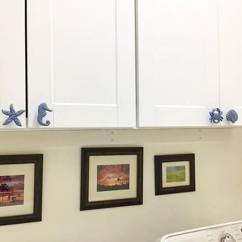4 Piece Mediterranean Blue Iron Cabinet Knobs Set With Seahorse, Starfish, Crab, And Shell Handles on white cabinets