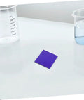 Must Have Set Of 2 Cobalt Glass Sheets 5x5cm for Chemistry Flame Color Reaction Tests on lab bench with beakers