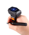 Hands Free Wearable Ring Barcode Scanner With 3 In 1 USB Wired 2 4G Wireless And Bluetooth Capable 2D QR Data Matrix Reader For iPad Phone And PC With 330 Degree Adjustable Ring shown on a hand holding a pen.