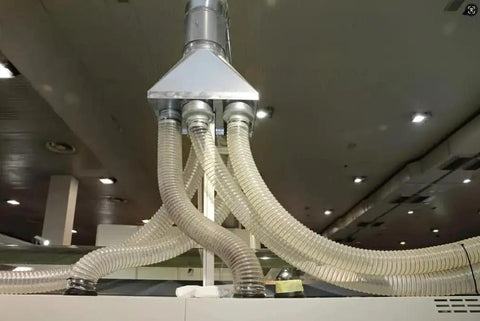 Shop Tested Heavy Duty Clear Flexible Dust Collection Hose 1 1/2 Inch By 20 Feet connected to a central filtration unit.