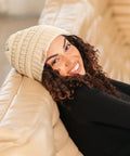 Woman wearing Satin Lined Beanie For Curly Hair Women Cozy Cable Knit Winter Hat With Frizz Free Moisture Retaining Satin Interior