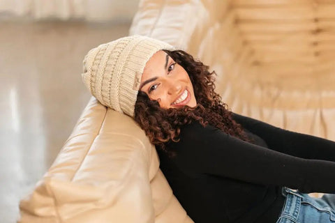 Woman wearing Satin Lined Beanie For Curly Hair Women Cozy Cable Knit Winter Hat With Frizz Free Moisture Retaining Satin Interior