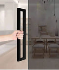 Heavy Duty Commercial Grade Push Pull Door Handle Rock Solid Matte Black Finish Barn Door Pull used on a glass door.