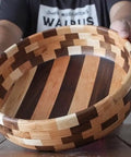 Person holding handmade wooden bowl with striped pattern, showcasing craftsmanship and design. Cutting Board Oil For Wood And Butcher Block, 32 Oz Jug, FDA Food Contact Safe, Food Grade Mineral Oil, Made In USA, Pro Kitchen Quality For Dark Wood, Non Toxic, Odorless Finish, Keeps Surfaces Sealed Like A Boss.