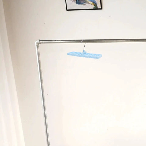 Sleek Belt And Tie Organizer Rack With Foldable Hooks Designed For Compact Closet Spaces Kick Your Wardrobe Into High Gear Keep Accessories Neatly Secured Easy Install Blue hanging from a metal rod.