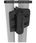 Close-up of TruClose Self Closing Round Post Gate Hinges Built Tough For Chain Link Gates Up To 154 Pounds Fits 1 3 8 Inch And 1 5 8 Inch Gate Diameters For Round Frame And Post Black 2 Count installed on gate post