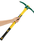 Person holding Heavy Duty 24 Inch Pick Mattock Hoe with Forged Steel Head and Fiberglass Handle for Loosening Soil Weeding Prospecting