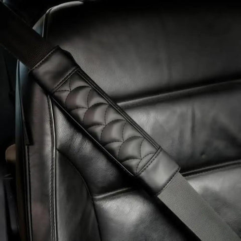 Premium Leather Seat Belt Cover For Tesla Cybertruck Featuring Quilted Smooth Surface on black seat with cushion