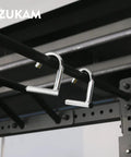 Heavy Duty Metal Resistance Band Handles With Knurled Steel Grip Surface for Elastic Band Workouts and Pull Ups installed on a rig.