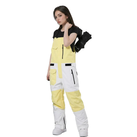 Model wearing yellow and white waterproof insulated ski bibs with black zippers, showcasing windproof adjustable snow overalls.