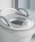 No Fuss Potty Training Toilet Seat For Toddlers With Sturdy Handles on a standard toilet, gray rubber base, compact design.