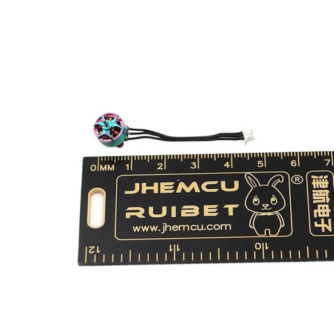27000KV FPV Brushless Motor For 1S LiPo Tiny Indoor Drones Ultra Light 1.85g next to ruler for size reference