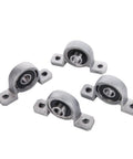 Four ball-mounted pillow block bearing inserts with 8 mm bore and mounting ears