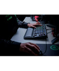 Classic Black Tenkeyless Mechanical Gaming Keyboard With Tactile Orange Switches And Smooth RGB Backlighting in use with a mouse.