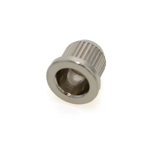 Close-up of a single solid brass bass string ferrule, 8mm bore, knurled rear-mount through-body style