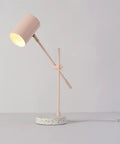 Playful Glam Desk Lamp With Adjustable Height And Balance Arm, Matte Pink Finish With Brass Accent And Terrazzo Base, In Line Rocker On Off Switch, Ideal For Home Office And Study Nooks, showing side profile on gray background