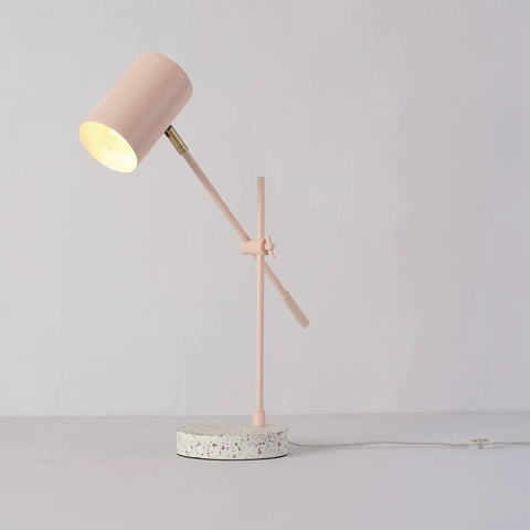 Playful Glam Desk Lamp With Adjustable Height And Balance Arm, Matte Pink Finish With Brass Accent And Terrazzo Base, In Line Rocker On Off Switch, Ideal For Home Office And Study Nooks, showing side profile on gray background