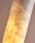 Close-up of Alabaster Pendant Light Natural Marble Long Tube Hanging Lights showing translucent marble pattern and warm glow.