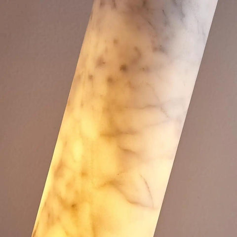 Close-up of Alabaster Pendant Light Natural Marble Long Tube Hanging Lights showing translucent marble pattern and warm glow.