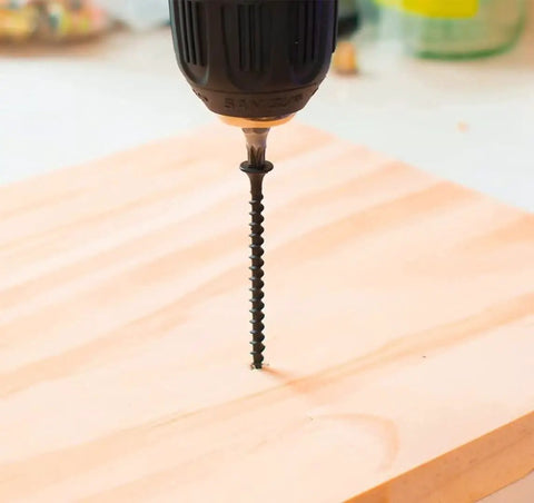 Tough As Nails Size 8 X 1-1/4 Inch Drywall And Wood Screws 200 Piece Pack black phosphate coated screw being drilled into wood.