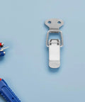 Check Out These 10 Pieces Of Premium Stainless Steel Toggle Latch Clamps With Silver Finish Perfect For Securing Boxes Cases Cabinets And Furniture With Smooth Spring Loaded Operation That Is Totally Built Heavy Duty Industrial Strength! Close-up of a stainless steel toggle latch clamp on blue background.