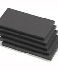Stack of black PEEK boards, part of the Black PEEK Board And Fiber Reinforced Anti Static PEEK Rod Kit, heavy duty polyether ether ketone plastic.