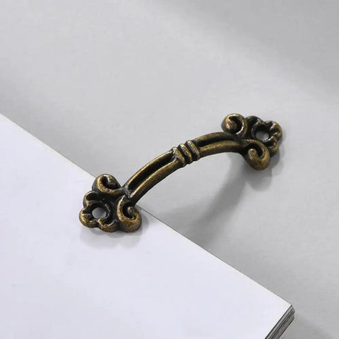 Vintage Bronze Mini Drawer Pulls Set Of 20, 1.85 Inch Antique Jewelry Box Handles, solid zinc alloy hardware mounted on white surface
