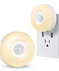 Motion Activated Plug In Night Light With Warm White LED 200 Lumen Ultra Bright Wall Nightlight Auto On Auto Off Sensor Energy Efficient Hallway Entryway Lighting 2 Pack shown plugged into wall outlet