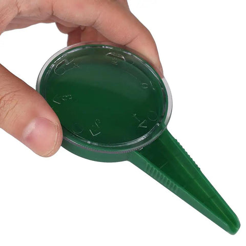 Hand holding Seed Spreader Garden Seeding Tool With Adjustable Dial For Even Planting, Army Green, 120 mm