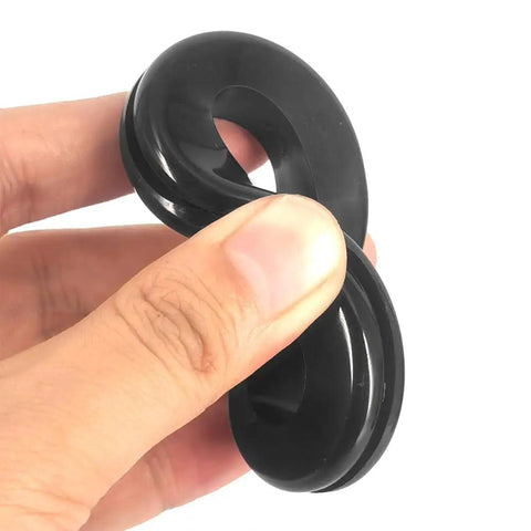 Kickass Heavy Duty Rubber Grommets For Wiring Harness Protection 2 Inch Inner Diameter Flame Retardant Heat Insulator Plug 4 Pack held in hand.