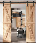Double wooden doors on Black Carbon Steel Barn Door Hardware Kit With 6 To 16 Ft Sliding Track And Rollers, installed in a living room.