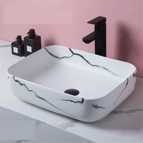 USZWBY Vanity Sink Imitation Marble Pattern Vessel Above Counter Basin Art Ceramic Bathroom Sink with elegant black faucet.